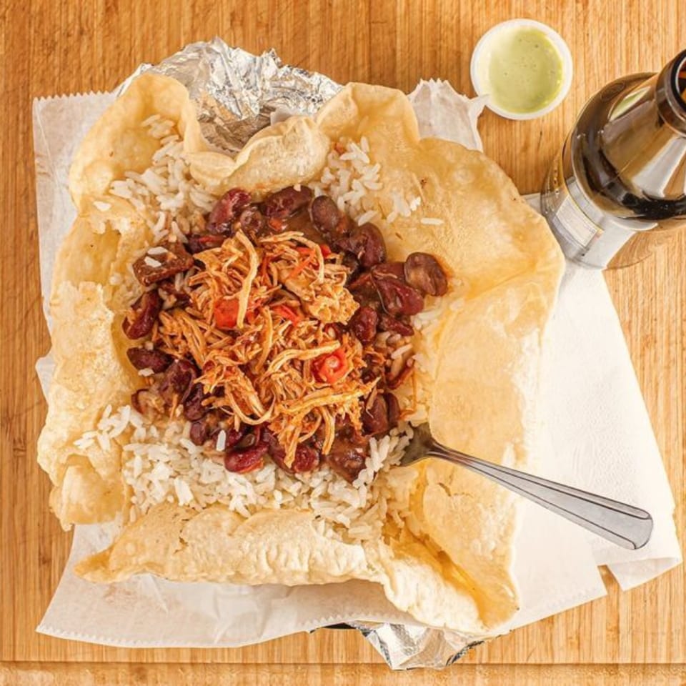 Chamo's Bagel & Grill's chicken, rice, and beans served in a fried dough shell with a drink.